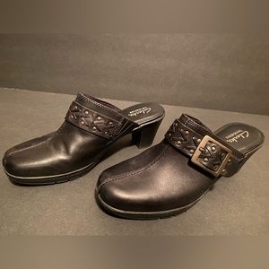 Woman’s black leather clogs